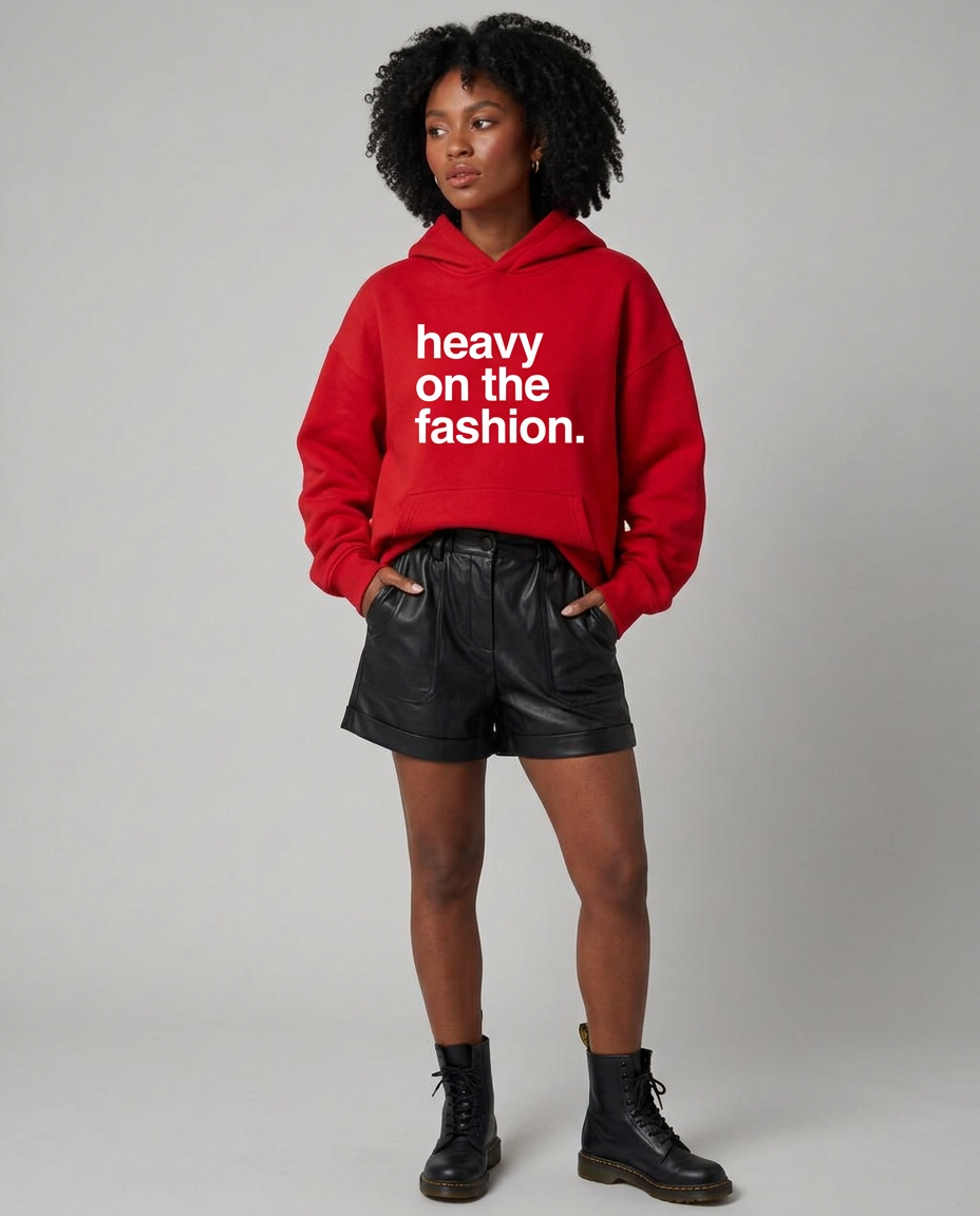 Model in the red Heavy On The Fashion hoodie with black leather shorts and combat boots
